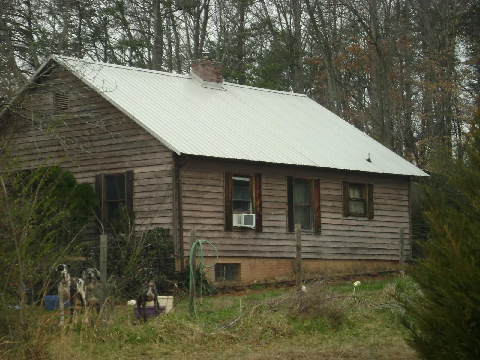 White metal roof on an old wood sided farmhouse, from a Asphalt Shingle Roof Repair job in Hoffman